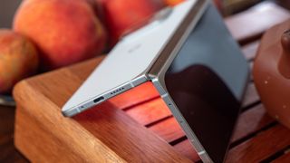 A Google Pixel 9 Pro Fold tented upside down with its display illuminated