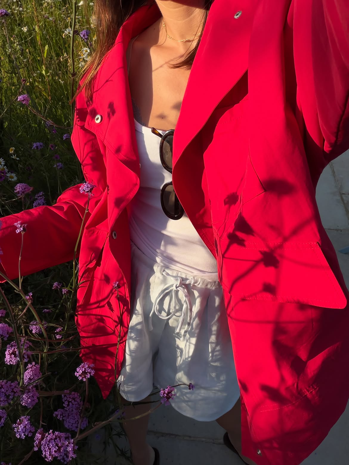 Red coat and white shorts.