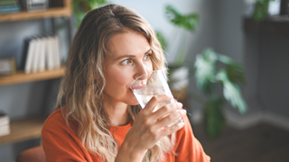 Woman sipping on glass of water