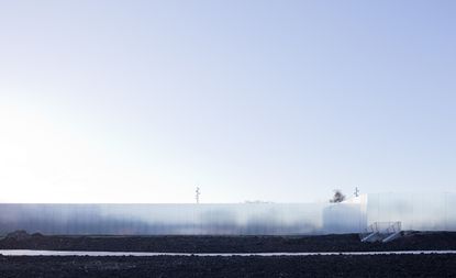 A landscape with a white, blurred screen shielding the building behind