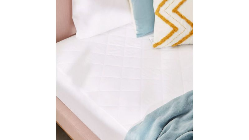 John Lewis mattress protector on a bed with cushions
