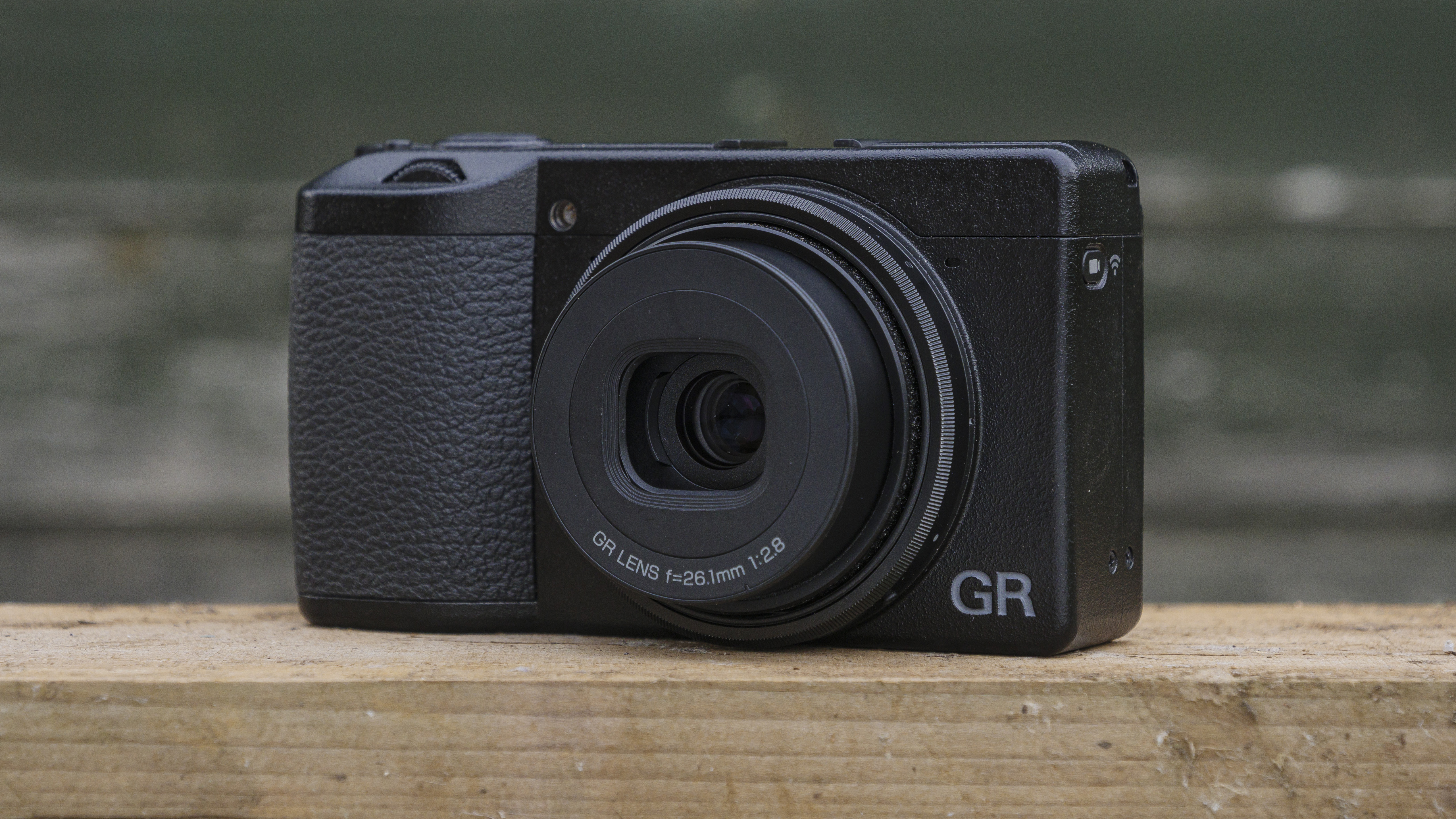 The Ricoh GR IIIx camera on a wooden table