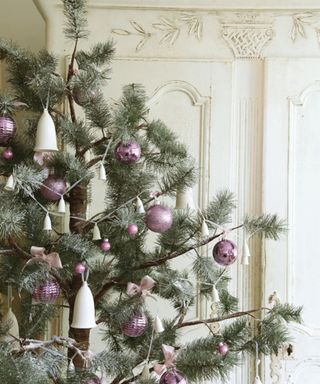 close up on a real Christmas tree with lilac baubles