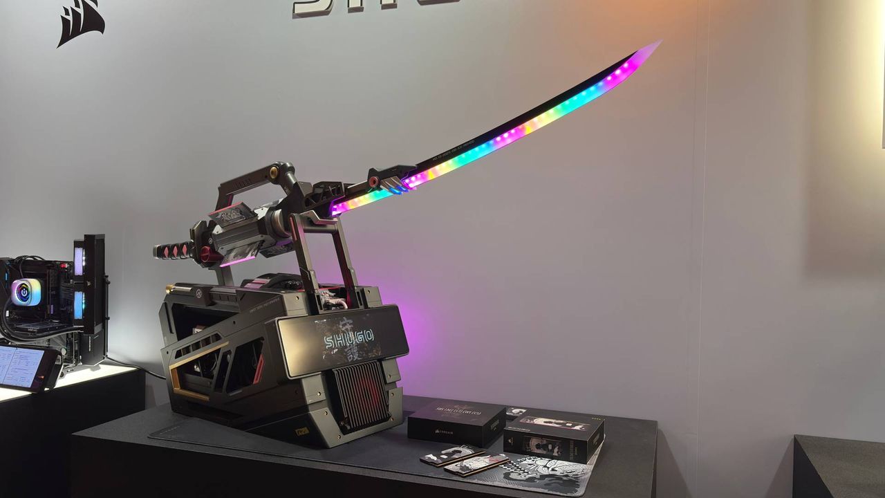 An RGB samurai sword on a pedestal that is actually a PC. The words 'Shugo' can be seen on the wall behind the exhibition piece from Corsair.