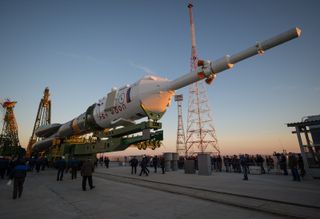 The Soyuz rocket is ready to be erected into position after being rolled out to the launch pad by train, on Sunday, October 21, 2012, at the Baikonur Cosmodrome in Kazakhstan.