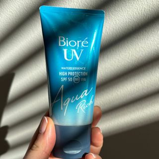 Laura holding Bioré UV Aqua Rich Watery Essence SPF 50 - best sun creams