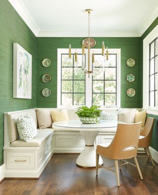 a dining room with green wallpaper
