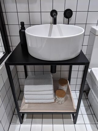 White bathroom sink with bespoke metal stand