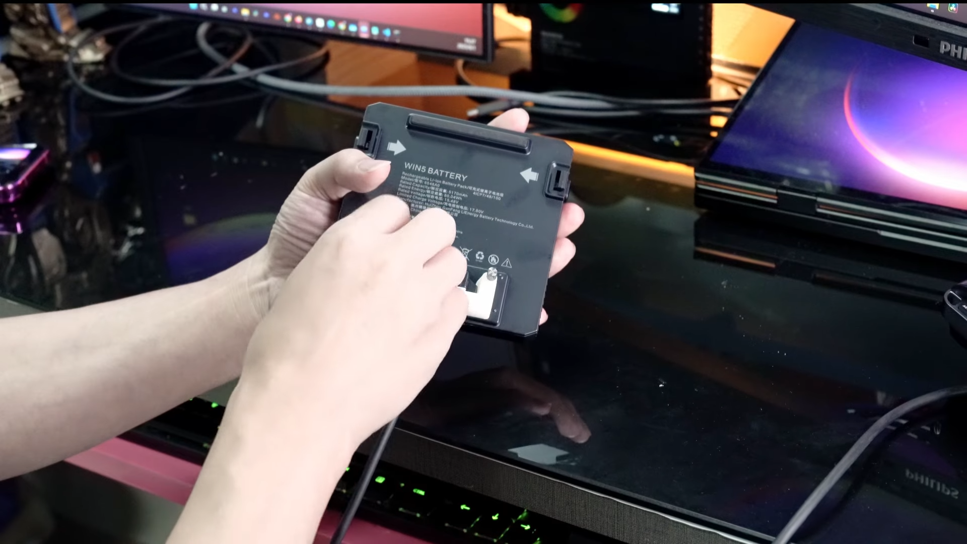 A screenshot of a video from GPD showing off it's new battery optional Strix Halo handheld