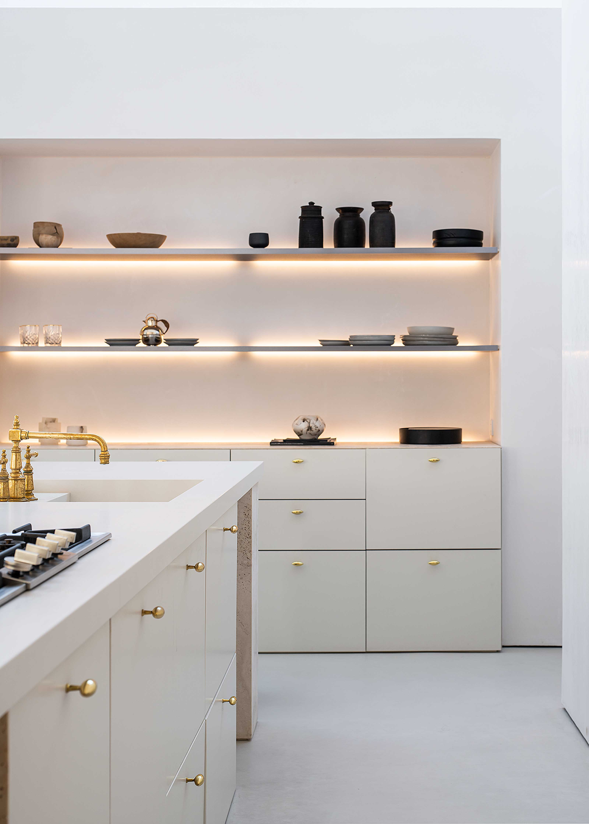 a kitchen with led strip lit shelving