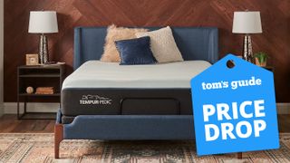 A Tempur-Pedic Tempur-LUXEbreeze Soft mattress in a bedroom with a Tom's Guide deals graphic