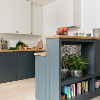 Kitchen with white and green-grey wood panelled cabinetry