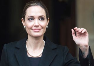 Angelina Jolie waves to photographers