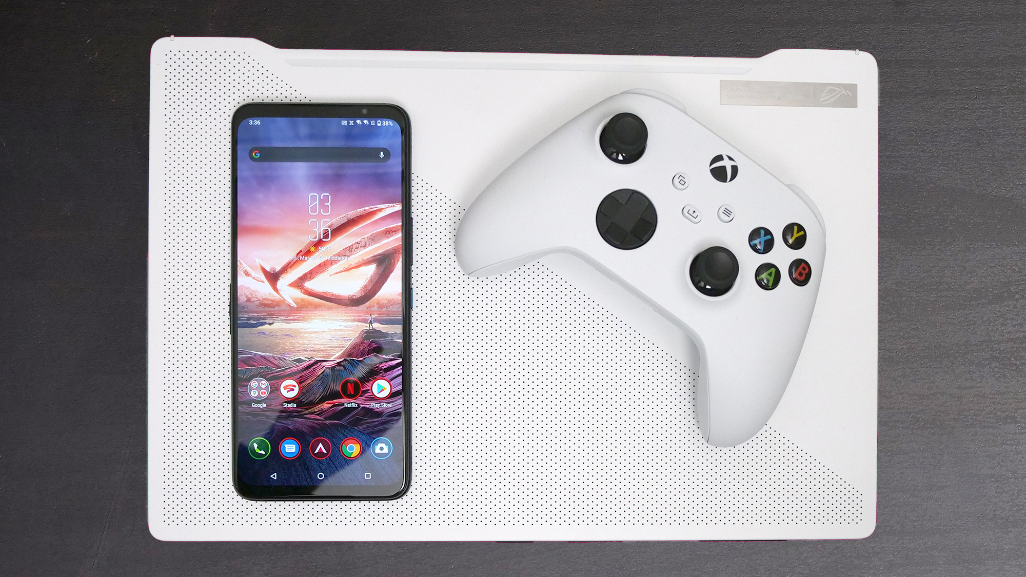 Asus ROG Phone 5 resting on Asus ROG Zephyrus G14 with Xbox Series X controller