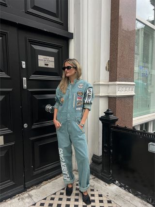 Eliza Huber wearing a Levi's x McLaren denim racing suit with black heels in London.