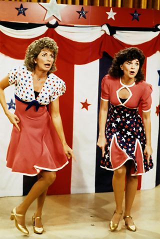 two women wearing patriotic dresses dancing in Laverne & Shirley