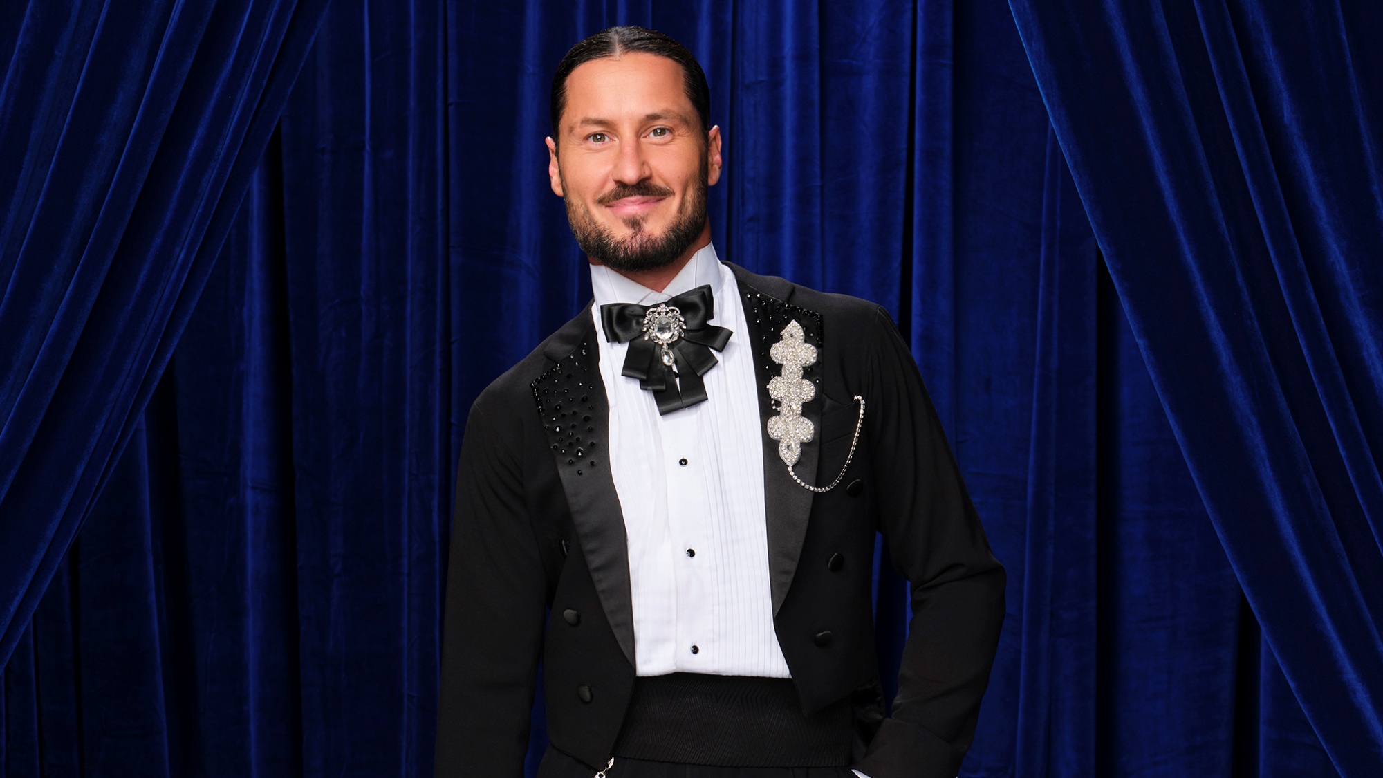 DWTS pro dancer Val Chmerkovskiy in a promo shot for Season 35 with a slight smile.