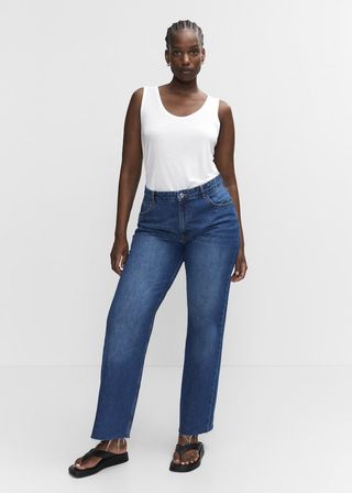 model wears white tank and blue jeans