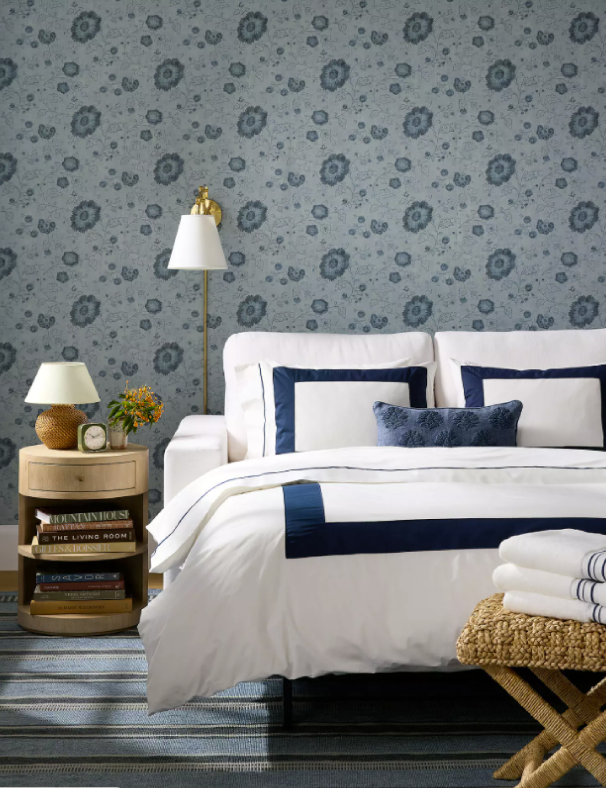 Serena &amp;amp; Lily white sleeper sofa styled for guests inside of a blue wallpapered bedroom
