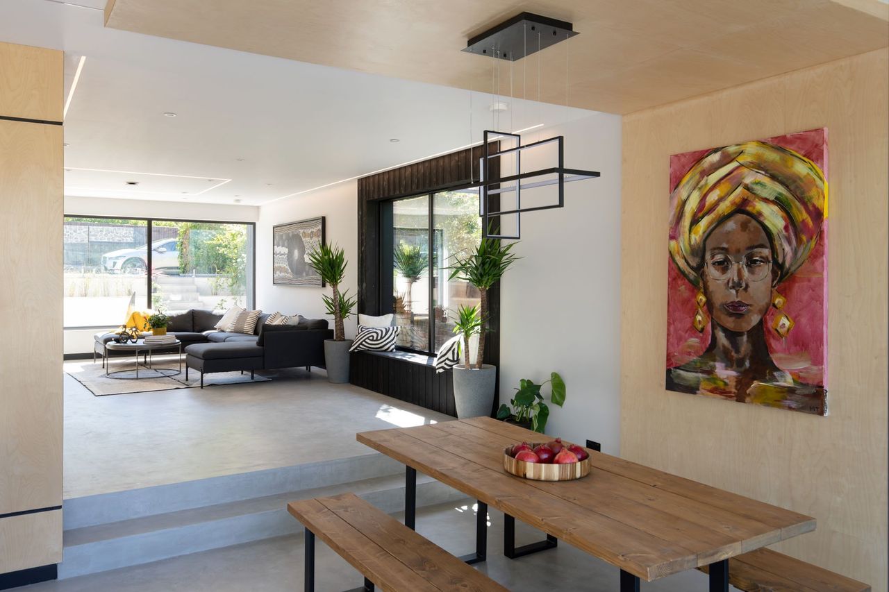 A shot of the living and dining area in the home with a stunning Zimbabwean portrait on the wall