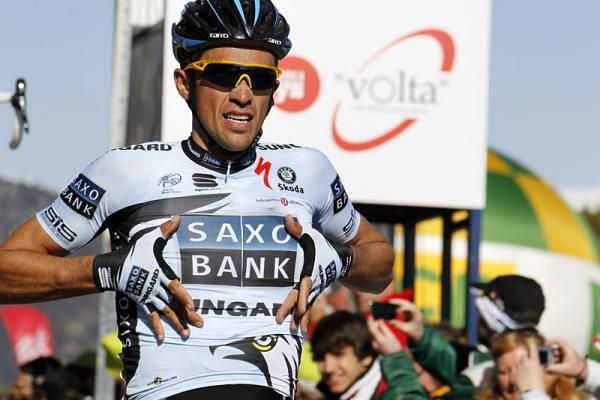 Stage winner Alberto Contador lets everyone know what team he rides for at the finish line.