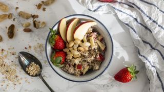 Bowl of porridge topped with apple