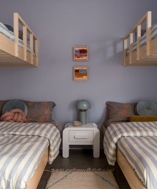 lilac childrens bedroom with bunk beds with striped bedding and lots of pattern play