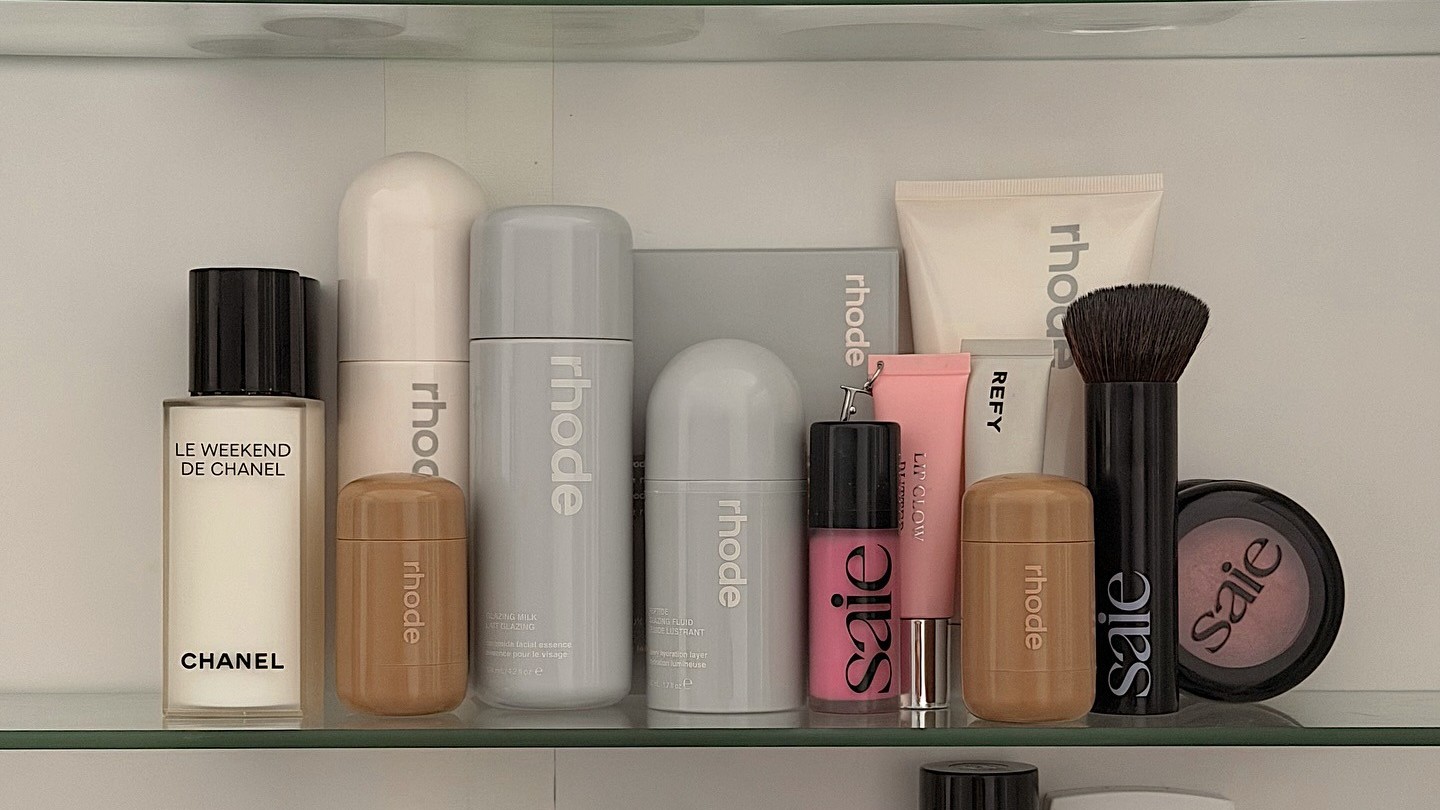 Photo of skincare and makeup products on a bathroom shelf