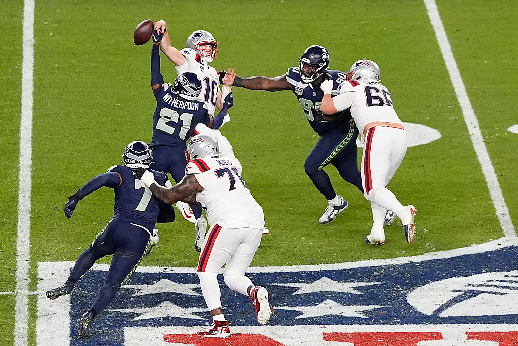 SANTA CLARA, CALIFORNIA - FEBRUARY 08: Devon Witherspoon #21 of the Seattle Seahawks forces a fumble against Drake Maye #10 of the New England Patriots during the fourth quarter in Super Bowl LX at Levi&amp;apos;s Stadium on February 08, 2026 in Santa Clara, California.  (Photo by Thearon W. Henderson/Getty Images)