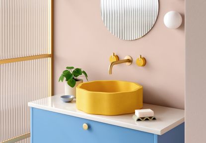 pink powder room with yellow sink and blue vanity