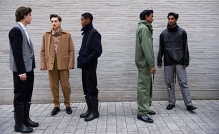 Five male models wearing clothing by Chalayan.