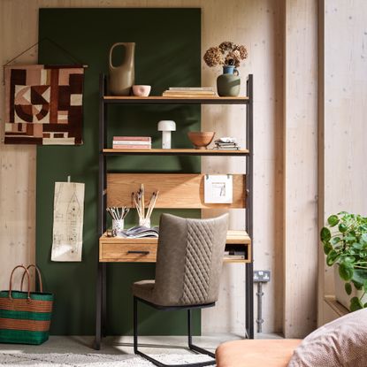 Wooden clad home office with green panel, wood desk and grey desk chair