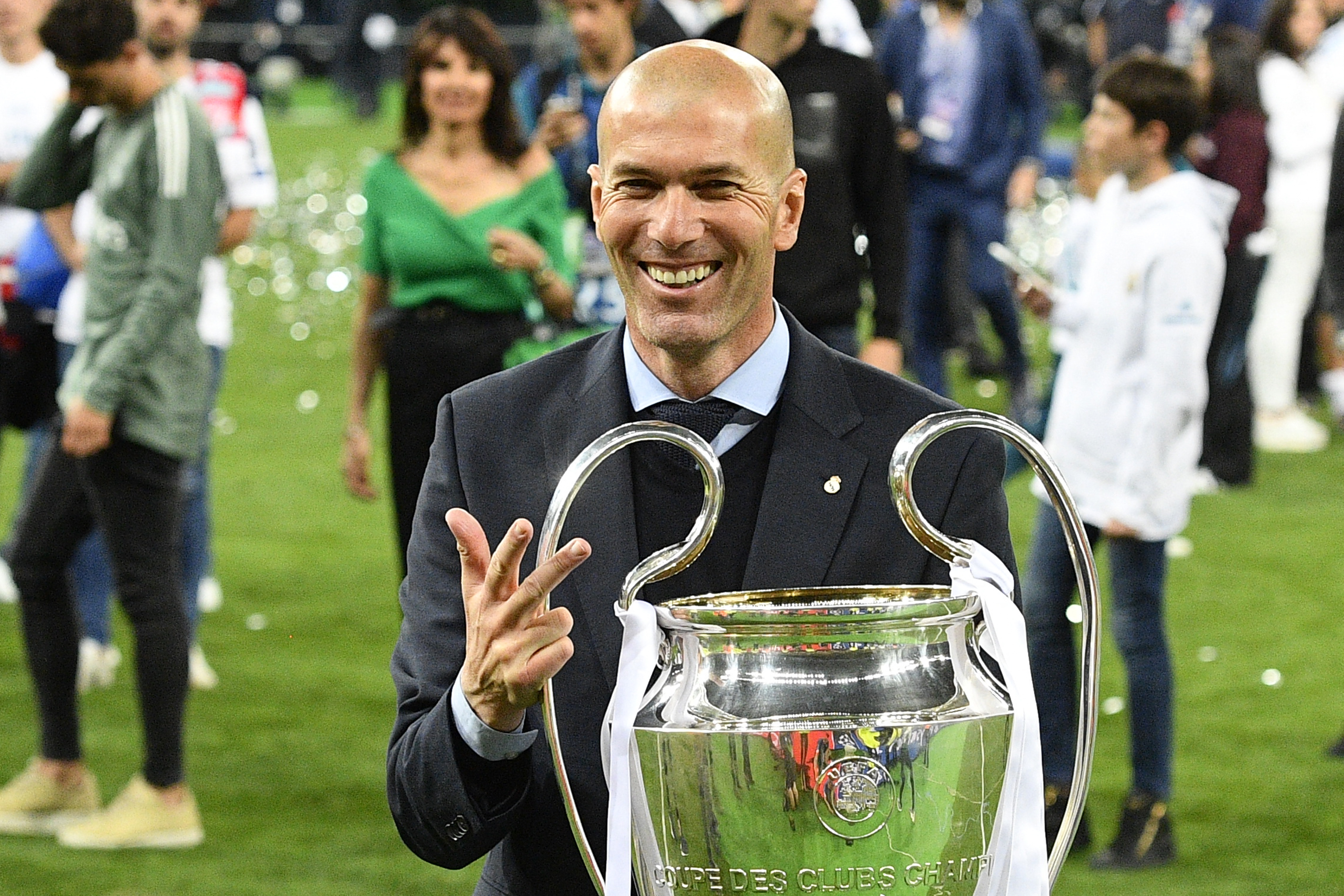 ZInedine Zidane celebrates with the Champions League trophy after leading Real Madrid to the title for a third year in a row in May 2018.