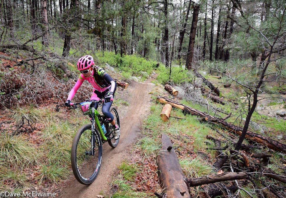 Emily Shields (NoTubes) riding sweet singletrack in a pine foerest