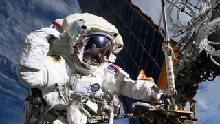 NASA astronaut and Expedition 72 Flight Engineer Anne McClain is pictured near one of the International Space Station&rsquo;s main solar arrays during a spacewalk on May 1, 2025 to upgrade the orbital outpost&rsquo;s power generation system and relocate a communications antenna.