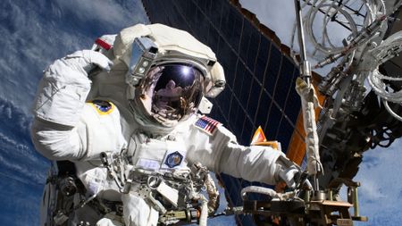 NASA astronaut and Expedition 72 Flight Engineer Anne McClain is pictured near one of the International Space Station&rsquo;s main solar arrays during a spacewalk on May 1, 2025 to upgrade the orbital outpost&rsquo;s power generation system and relocate a communications antenna.