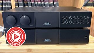 Naim separates on stand with Press Play logo