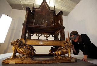 a tradesperson restoring the coronation chair from westminster abbey