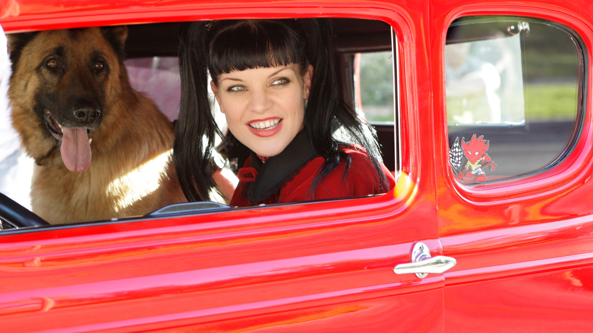 Abby in a car with her dog. 