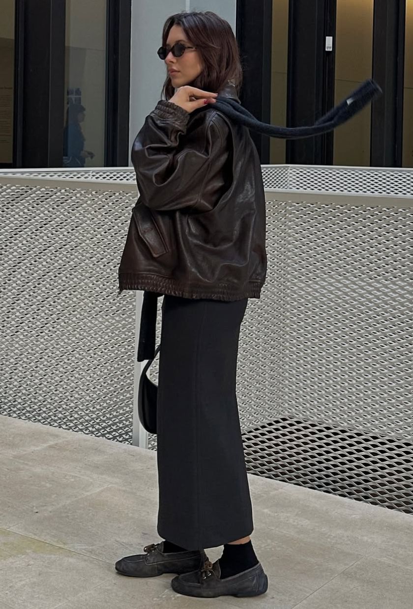 @deborabrosa wears a brown distressed leather bomber, black pencil skirt, boat shoes and grey scarf