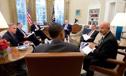 President Obama meets with Director of National Intelligence James Clapper (right) among other members of his security team.