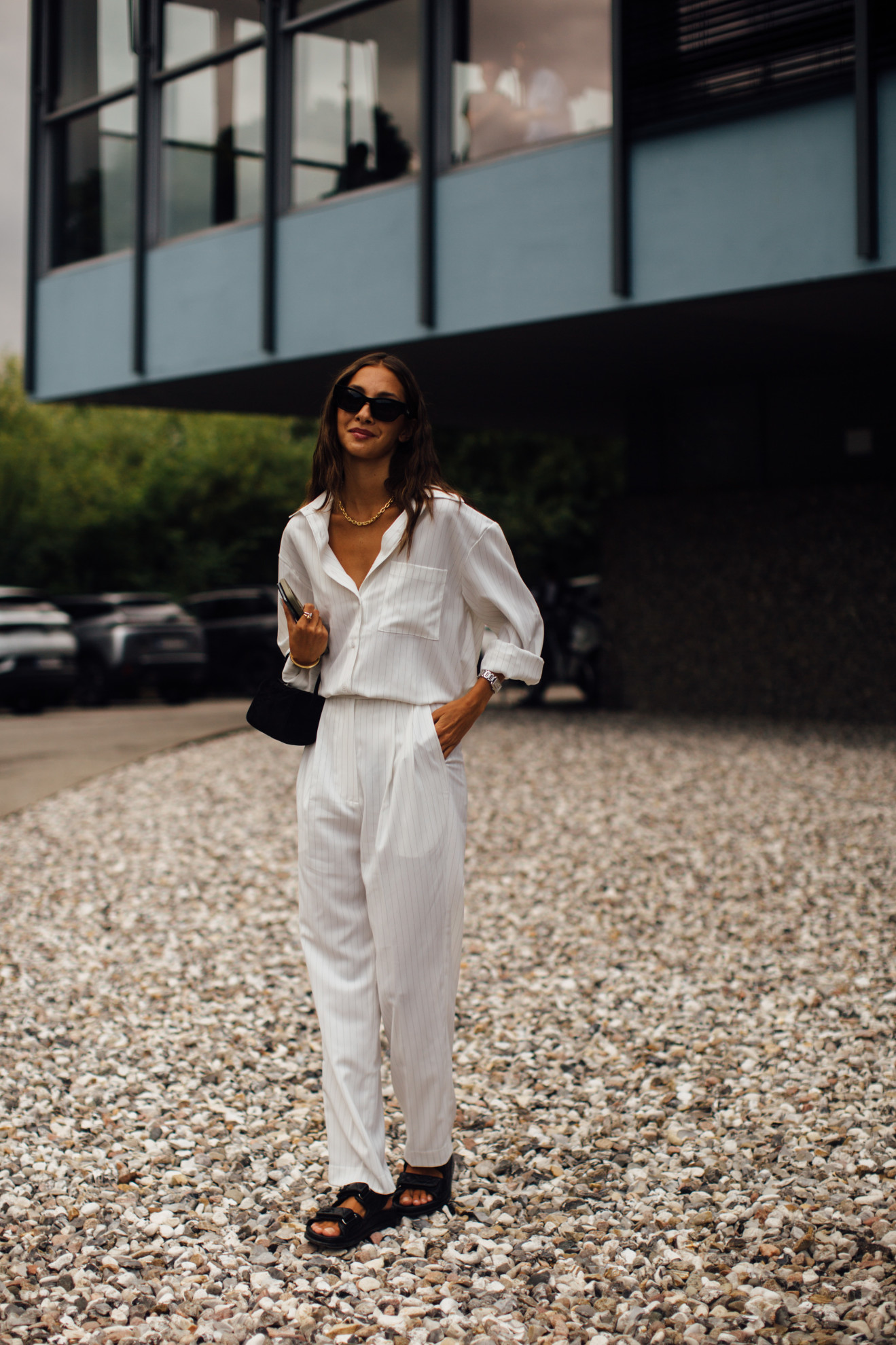 woman wearing white top, white pants, and sandals