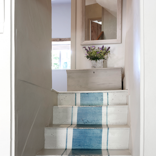 stairway with green wall and mirror on wall