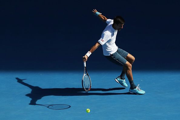 Novak Djokovic plays a backhand against Denis Istomin.