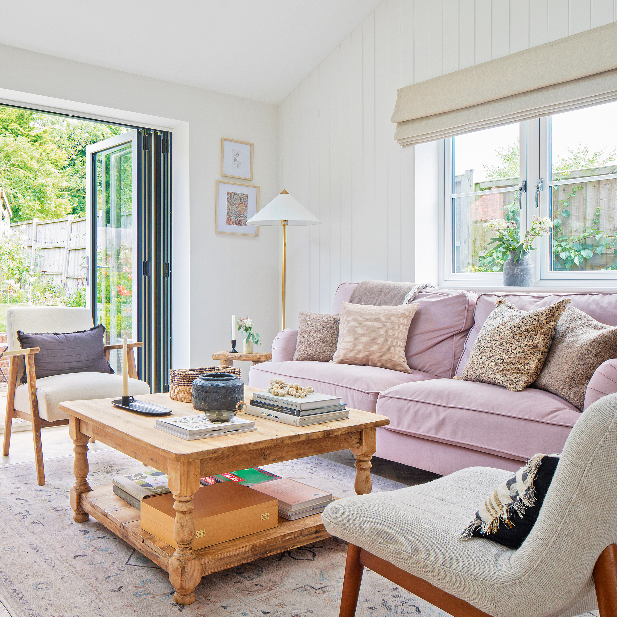 country cottage living room with classic furniture, pale pink sofa and neutral colour scheme