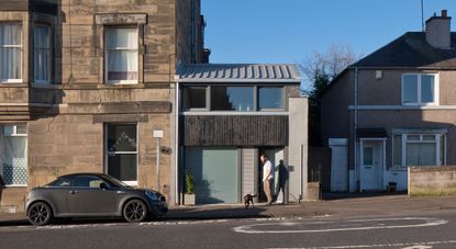 Former two-storey shop converted to a family home, with grey and black cladding