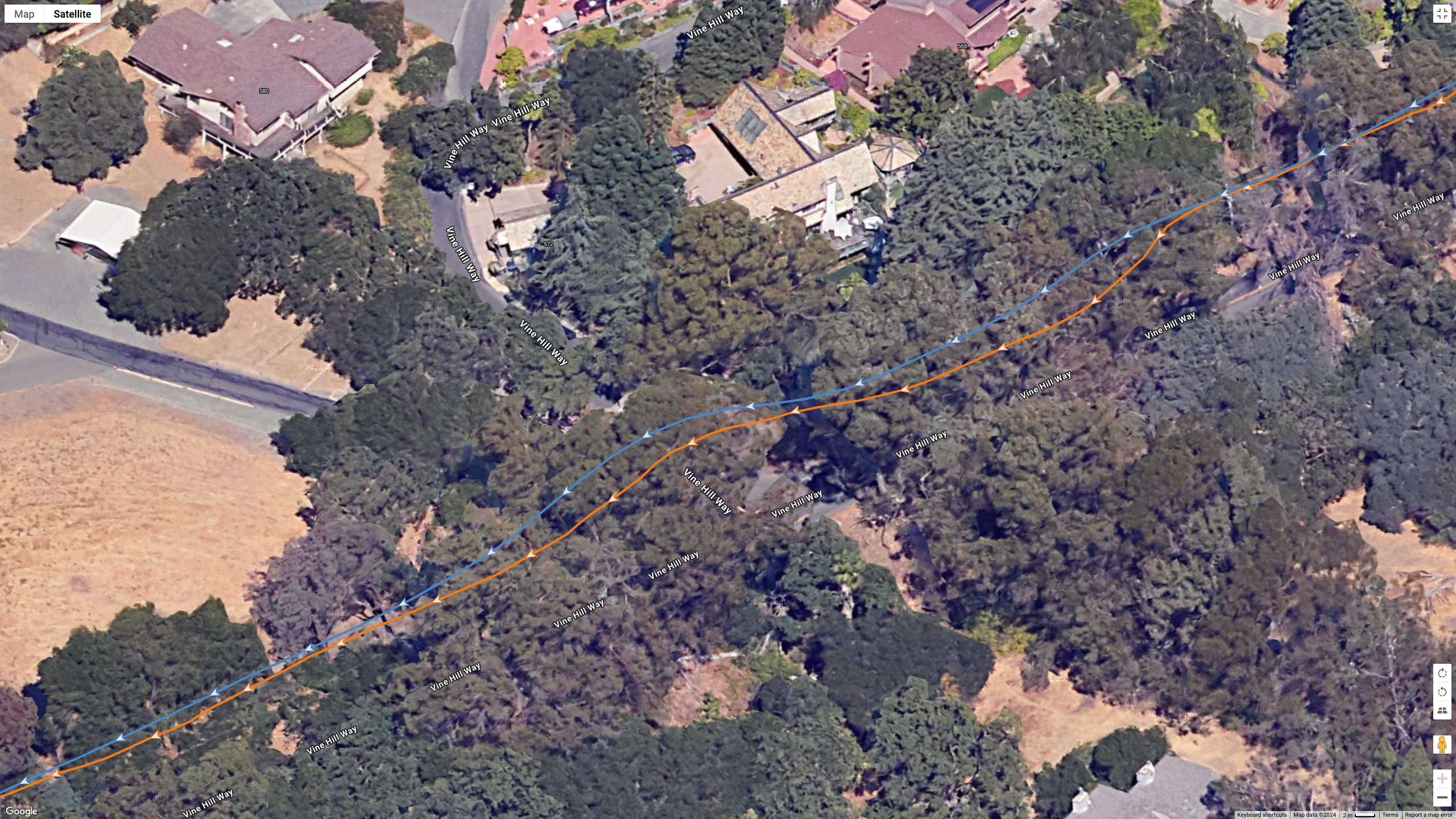 A Google Earth satellite image showing GPS lines for the COROS PACE Pro (blue) and Garmin Fenix 8 (orange) to test their dual-band GPS accuracy.