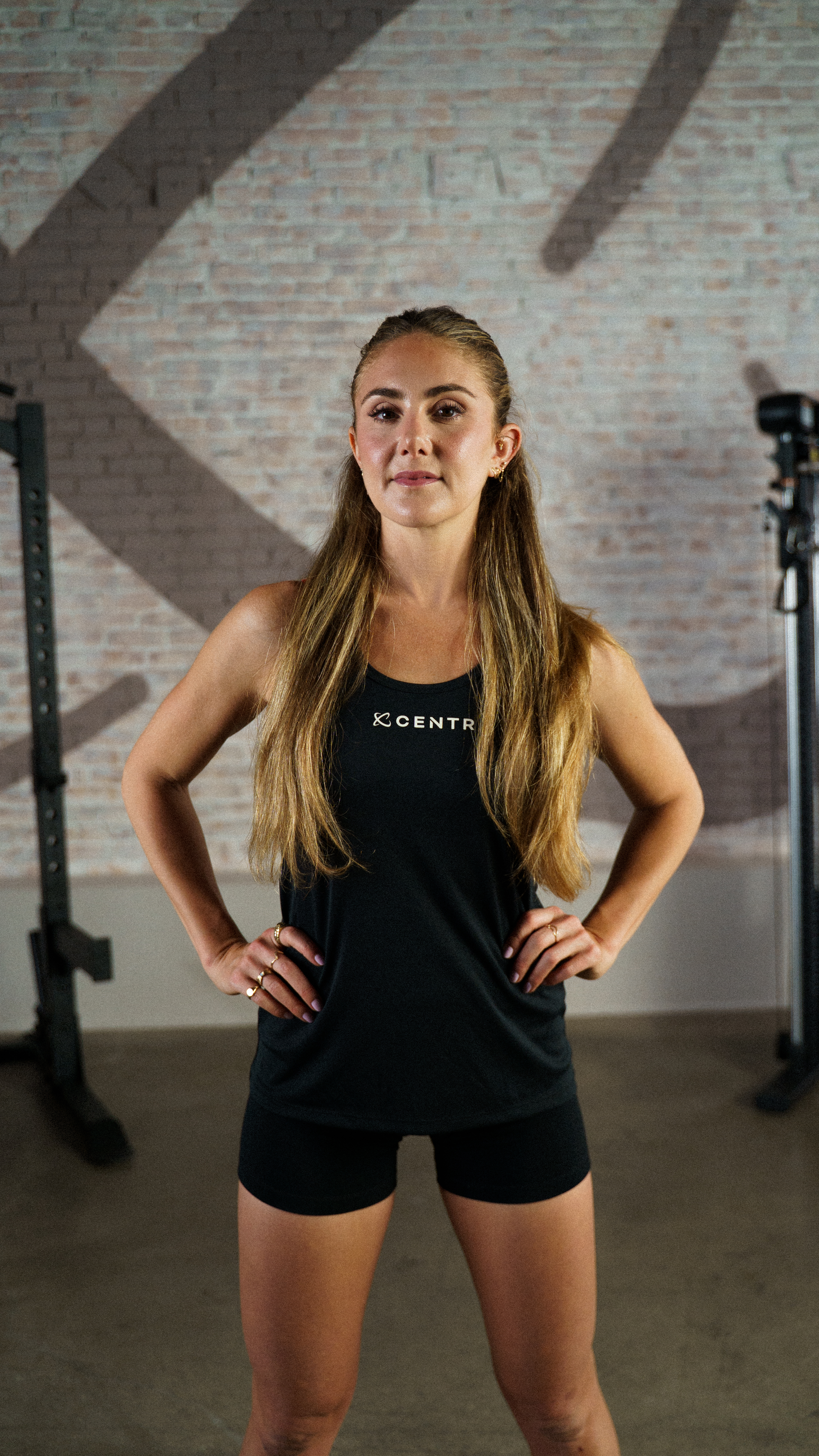 female personal trainer stands with hands on hips
