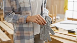 Woman putting on safety gloves