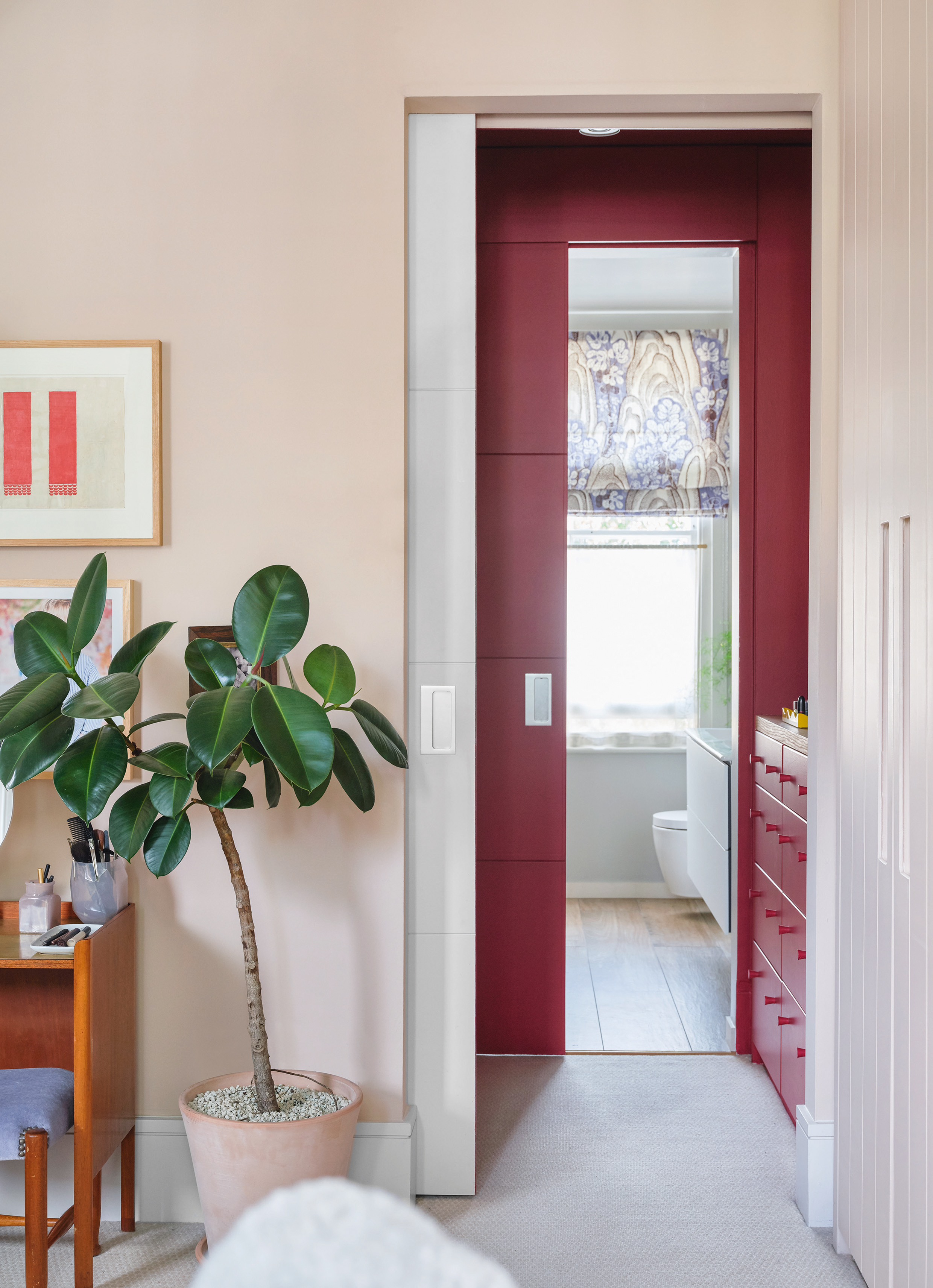 Pink bedroom with red ensuite doors